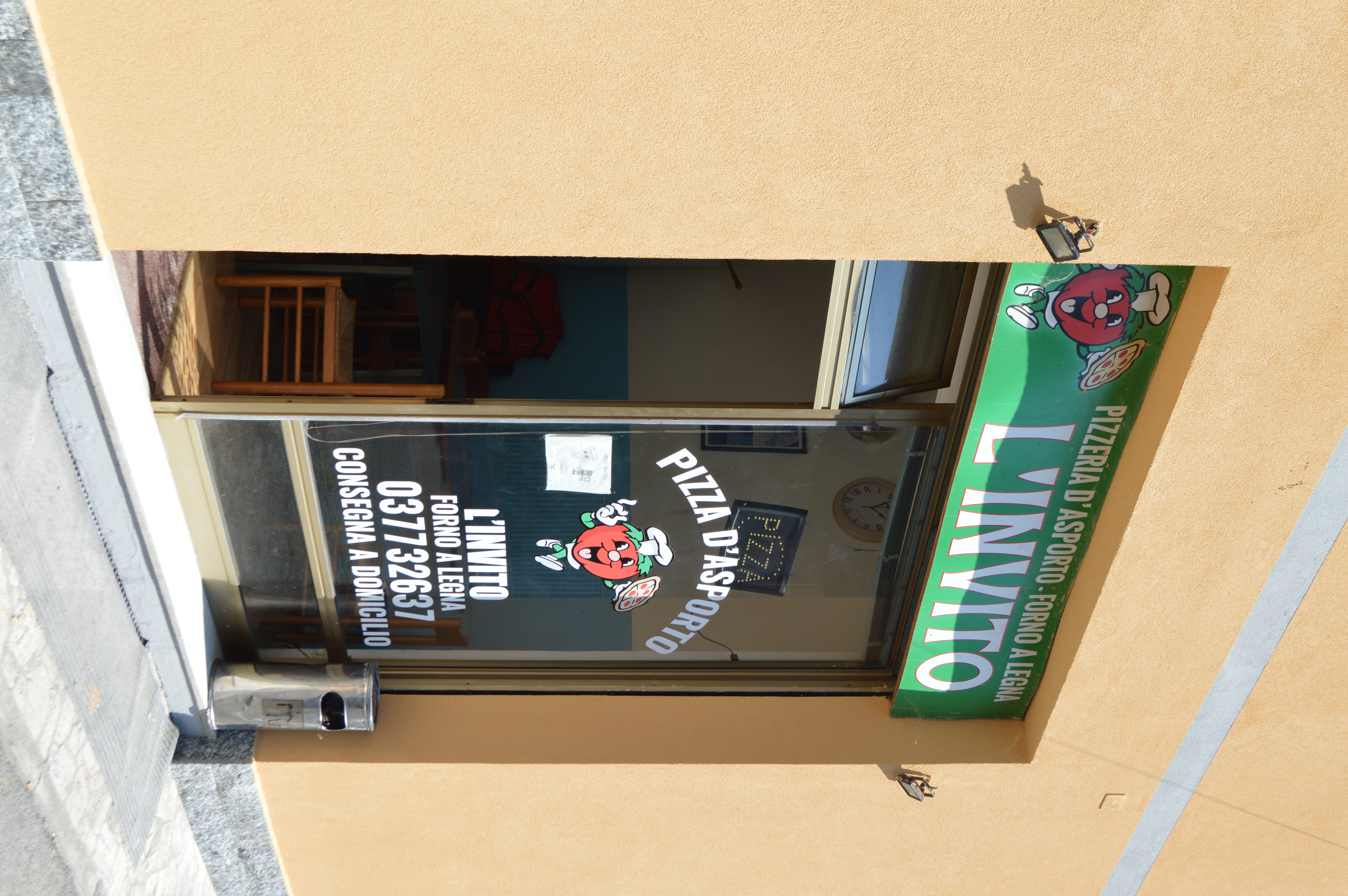 happy tomato holding a pizza